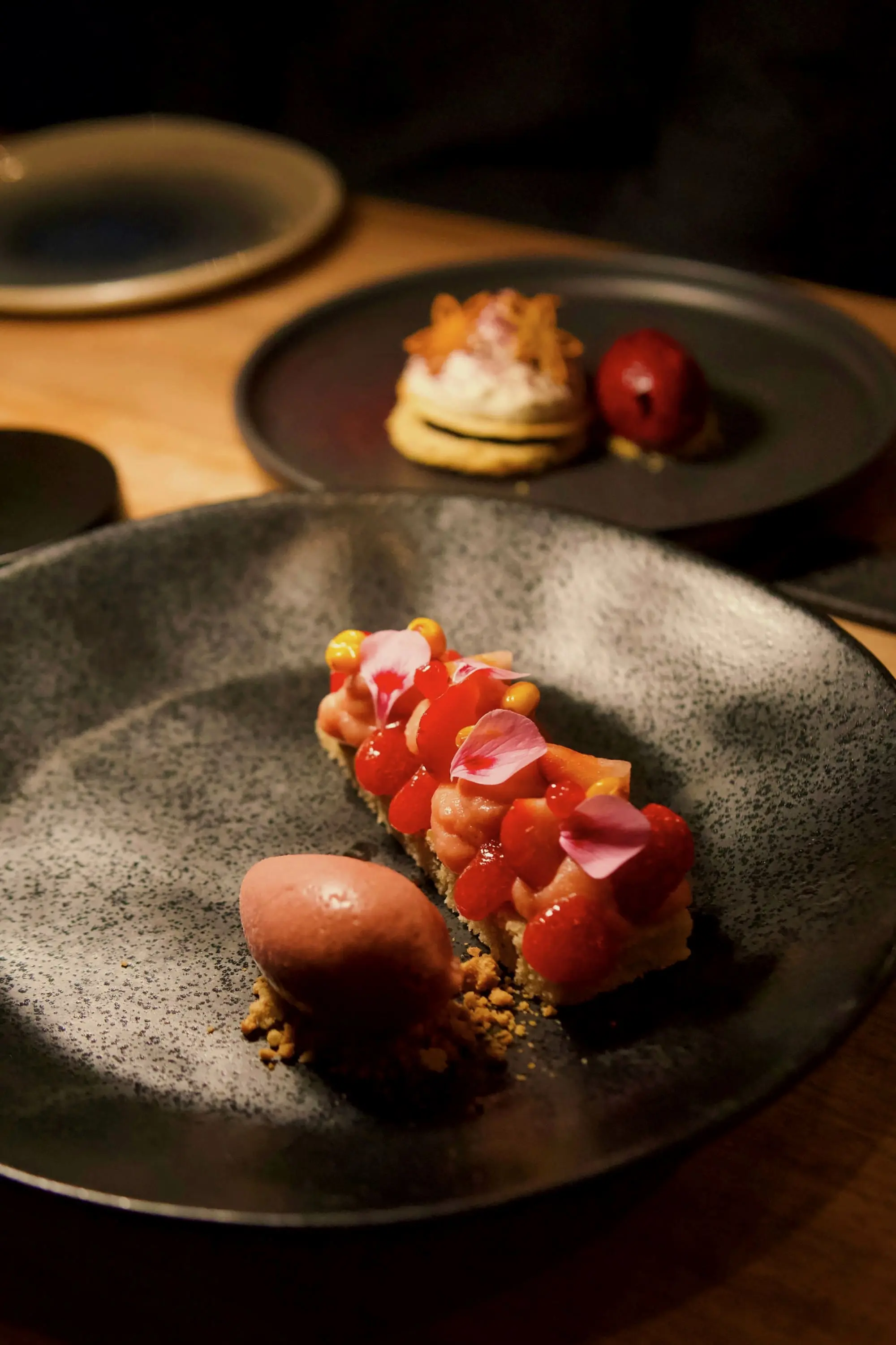 Fruit tart and sorbet on a speckled stoneware plate